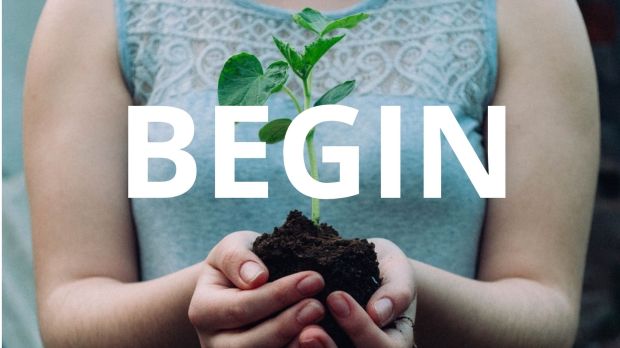 Woman holding sapling in her hands with the text "begin" written over the top